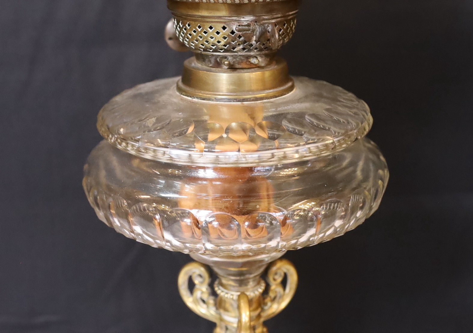 A late Victorian brass and cut glass oil lamp with duplex mechanism and frosted glass shade, height overall 65cm